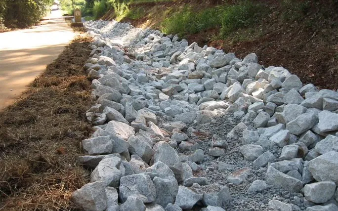 Large dry river bed built with natural stone by E&D Landscaping